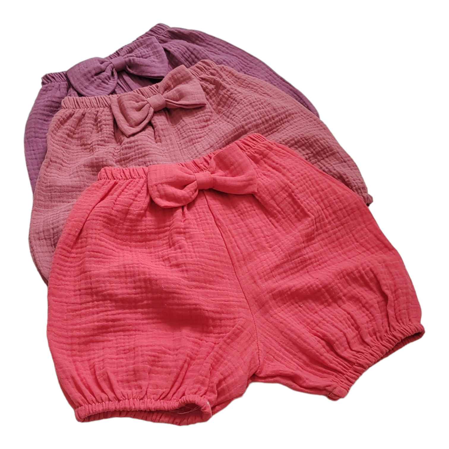 Pink baby bloomers with a bow, made from double gauze and muslin fabric, perfect for girls' 1st birthday photoshoots and cake smash.