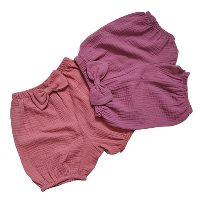 Handmade pink baby bloomers with bow detail, crafted from double gauze and muslin, ideal for newborns and baby shower gifts